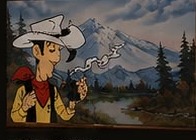 Vintage cowboy artwork against a mountain landscape